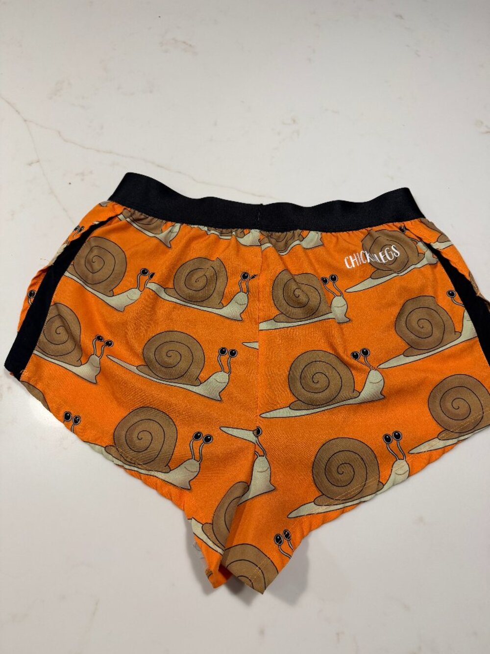 Chicknlegs Orange Snail-Print men’s running Shorts